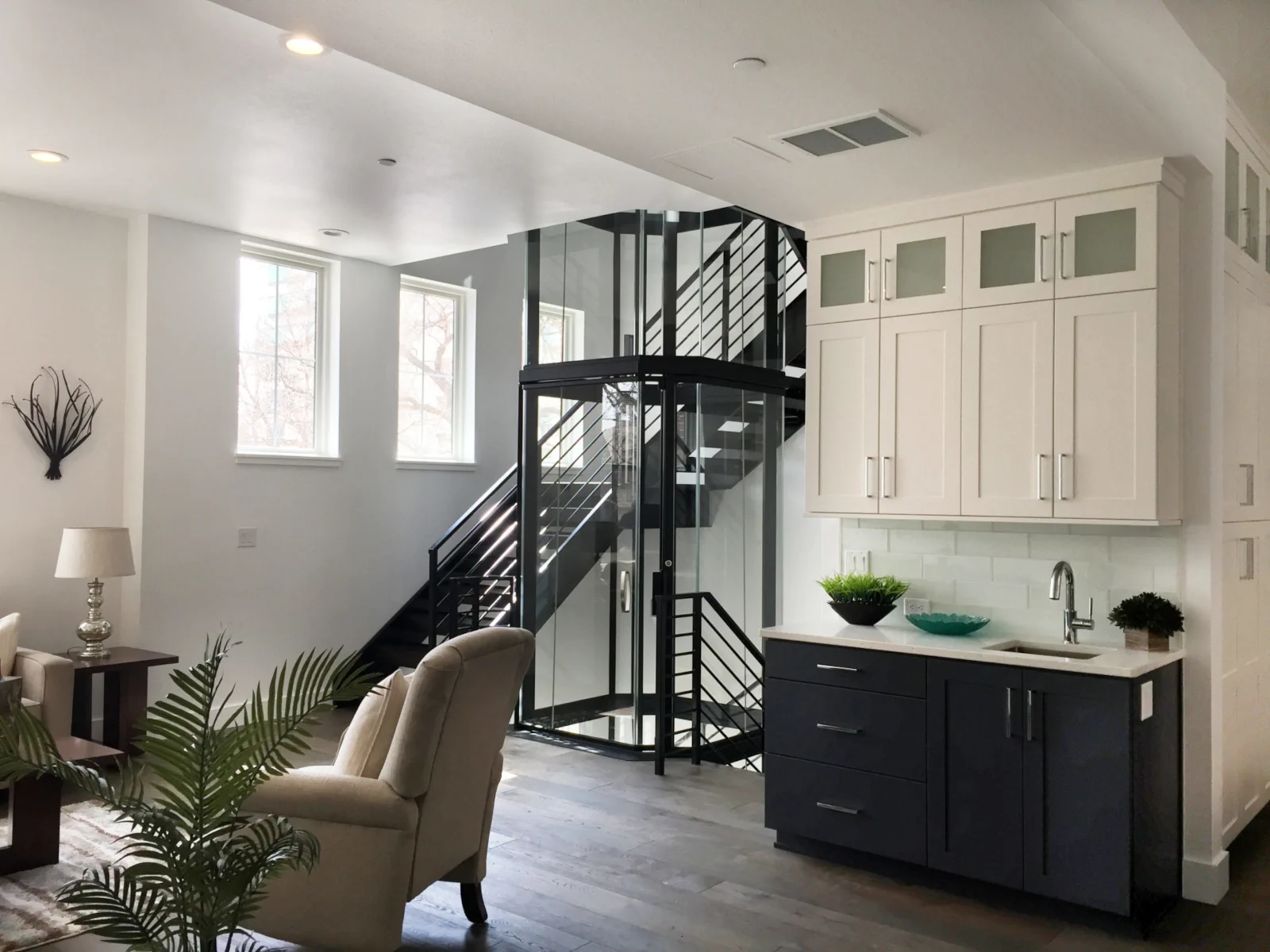 Savaria Vuelift round glass elevator on marble flooring in contemporary home